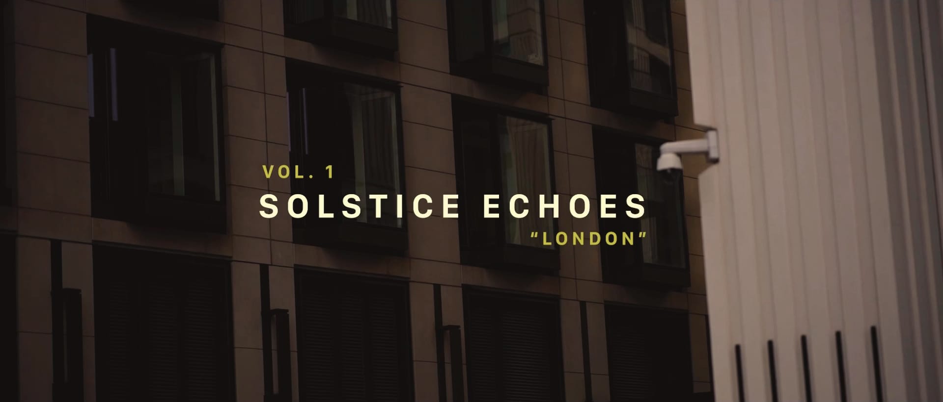 Title frame of Solstice Echoes: a figure walking past a London facade at dusk