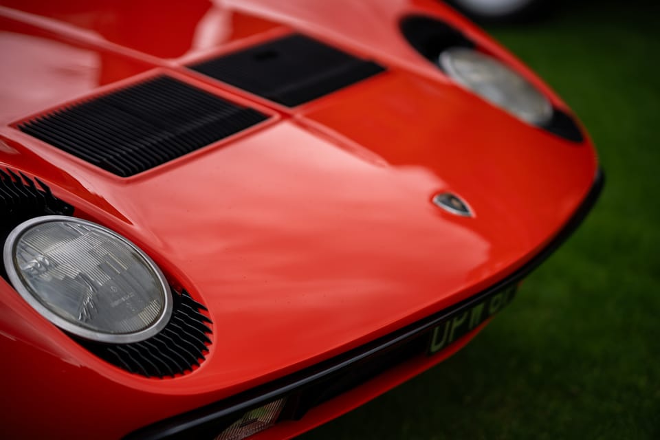 Nose of a red Lamborghini Miura on grass