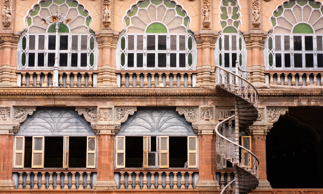 Indian palace facade with arches and a spiral stair