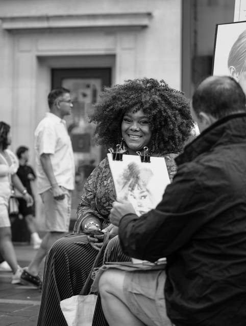 Woman smiling as a caricature artist draws her, black and white